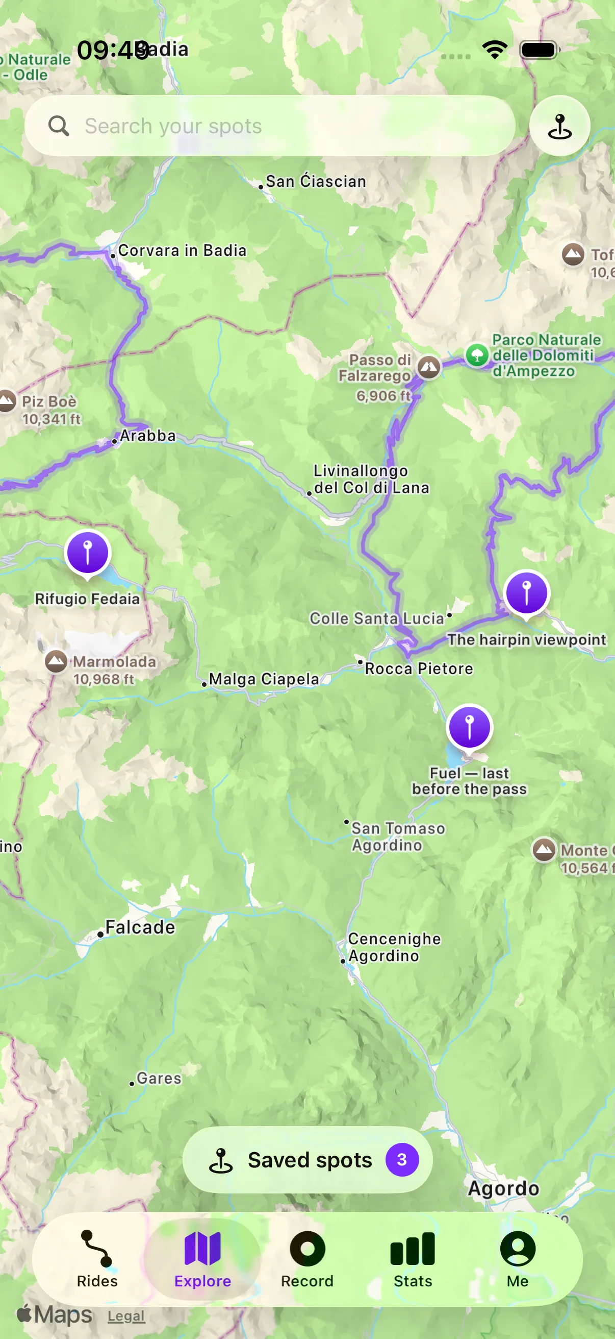 Qroda Explore tab: saved spots as pins on the map over your own ridden tracks, with the Saved spots chip floating above the tab bar